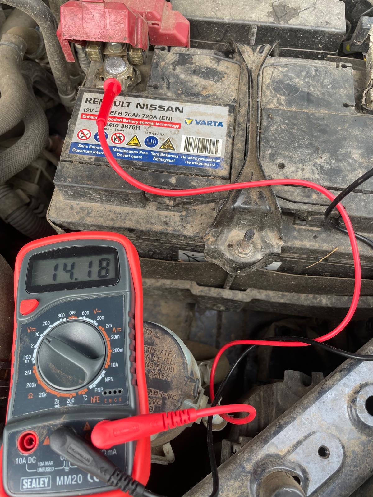 Multimeter reading 14.18V at tractor battery terminals with engine running — healthy alternator output
